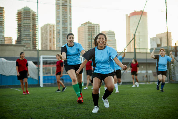 istock Women's soccer team celebrates scoring a goal in a competition. 1207665685