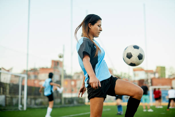 istock Soccer player controlling a ball with her knee in a training. 1207665714