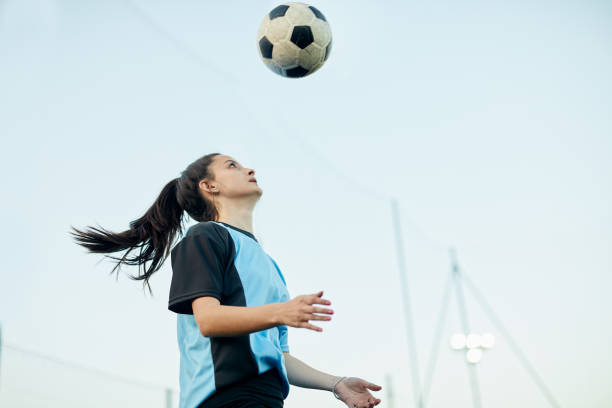 istock Soccer player striking a ball with her head in a training. 1207665728