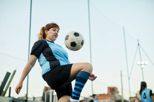 istock Soccer player controlling a ball with her knee in a training. 1207665733