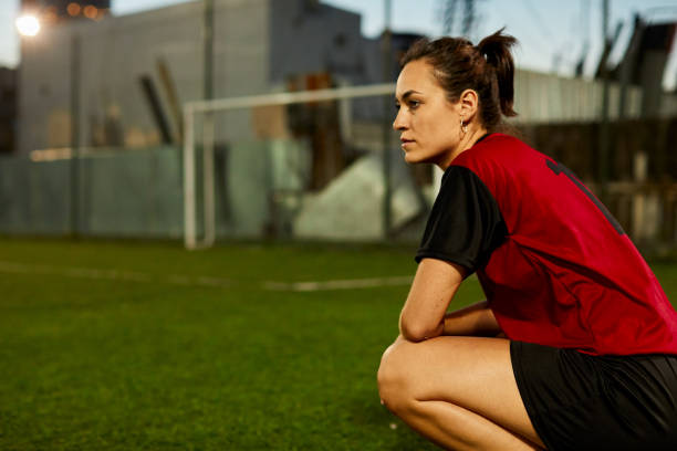 istock Young Argentinian female soccer player kneeling down after defeat. 1207665782