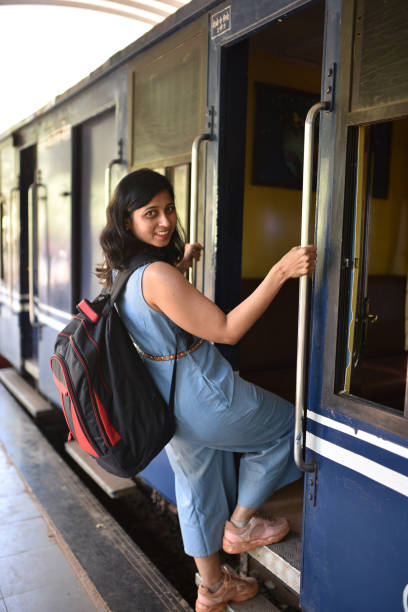 istock Woman boarding train from train station 1207665808