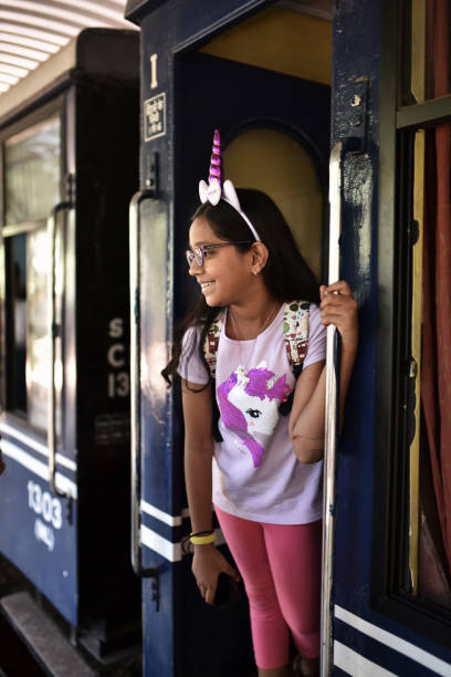 istock Preadolescent girl standing at door a train 1207665811