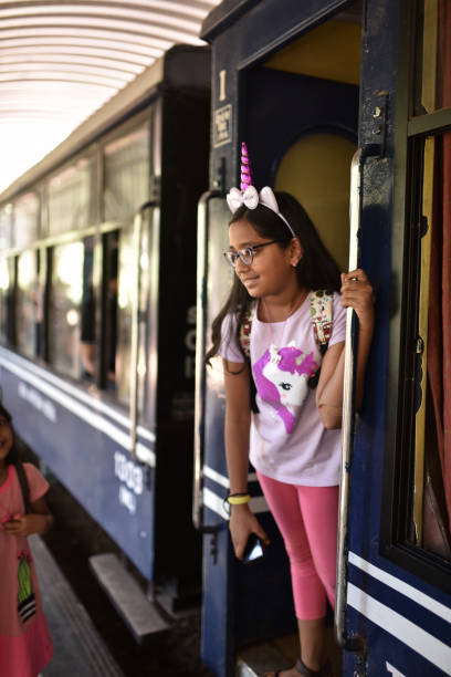 istock Preadolescent girl standing at door a train 1207665873