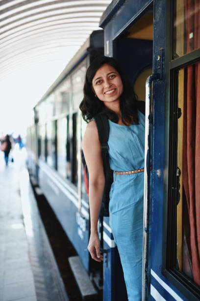istock Woman boarding train from train station 1207665886