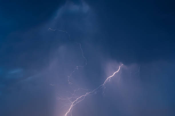 istock lightning in the night sky overcast flashes of bright light 1207667692