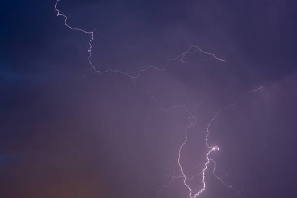 a web of lightning on the sky subtle bright curves in cloudy clouds at night