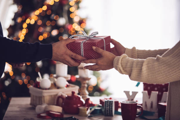 istock Unrecognizable heterosexual couple exchanging a Christmas gift 1207669691
