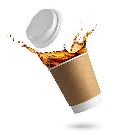 falling disposable paper cup with coffee splash isolated on white background