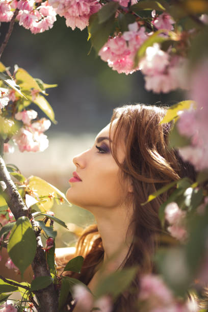 istock Woman at Blossoming Sakura Tree on Nature 1207679746