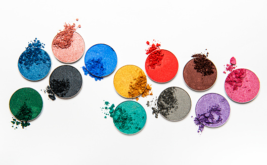 Assorted colors metallic blusher or eyeshadow  on white background. Flat lay, top view