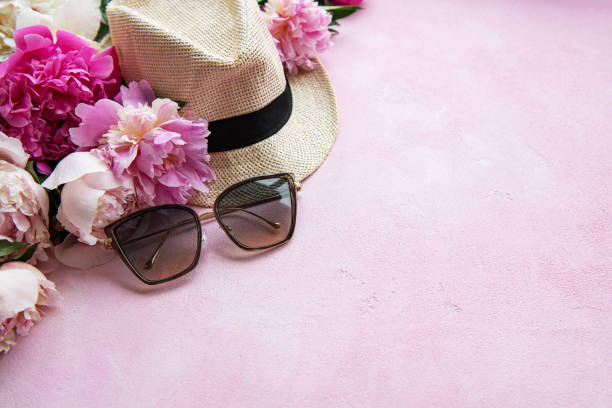 istock Pink peonies and hat on a pink concrete background 1207680737