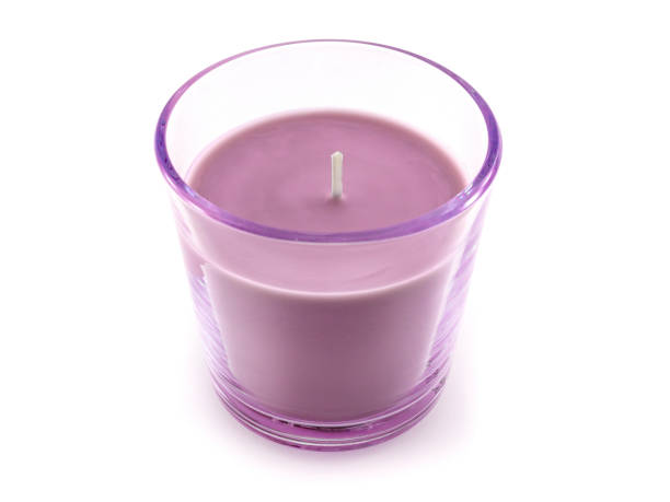 istock Pink candle in a glass candlestick on a white background 1207681440