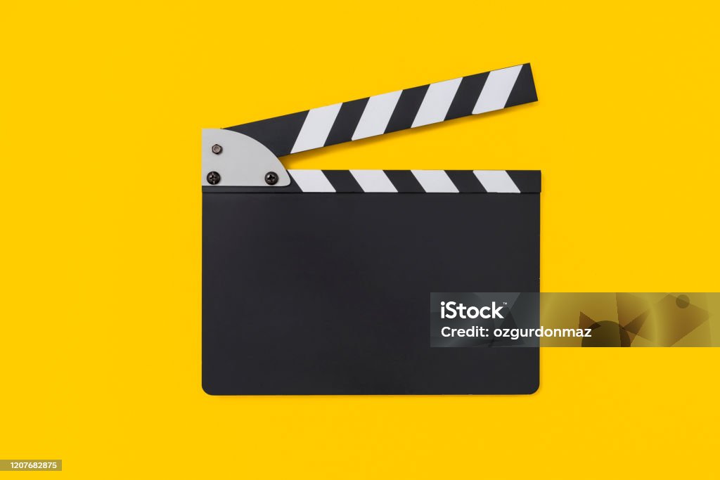 Movie clapper board on yellow background Movie clapper board on yellow background , with copy space Film Slate Stock Photo