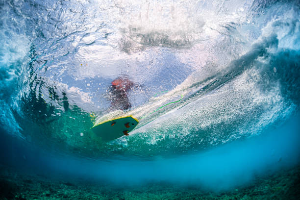 istock Underwater view of the surfer riding the wave 1207683815