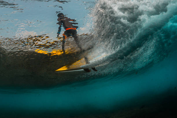 istock Underwater view of the surfer riding the wave 1207683901