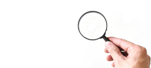 istock Hand holding magnifying glass isolated on white background 1207684568