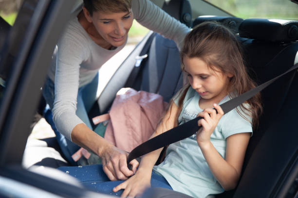 istock Mother Fastening Her Daughter's Seat Belt 1207685731