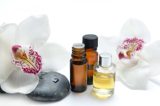 istock oil bottles and pebbles with beautiful orchids 1207687286