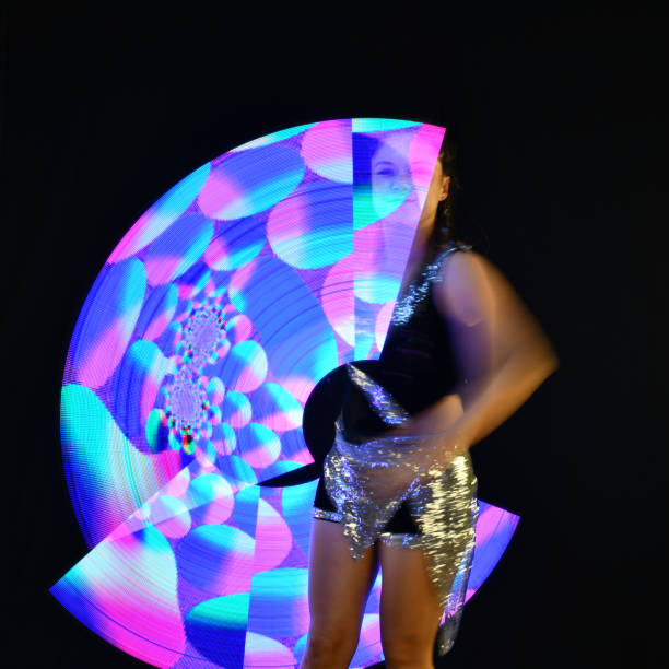 istock Young woman doing the show. Pixel poi. Led poi. 1207687596