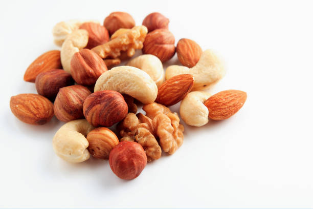 istock A bunch of assorted nuts on a white background. Healthy food and snacks. 1207691274