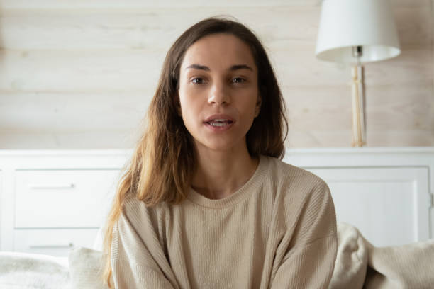 istock Millennial woman look at camera talk on video call 1207692013