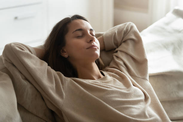 istock Calm millennial woman relax sleeping on couch at home 1207692025