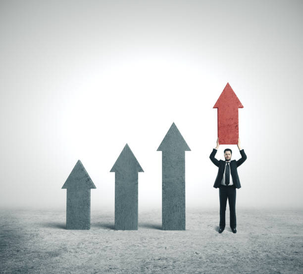 istock Businessman holding red arrow. 1207692057