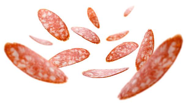 Sausage slices levitate on a white background Sausage slices levitate on a white background. sliced salami stock pictures, royalty-free photos & images