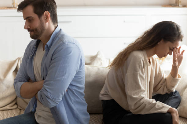 istock Upset young couple avoid talking after family fight 1207696832
