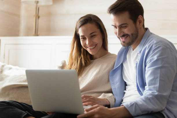istock Happy young couple relax at home using laptop 1207696835