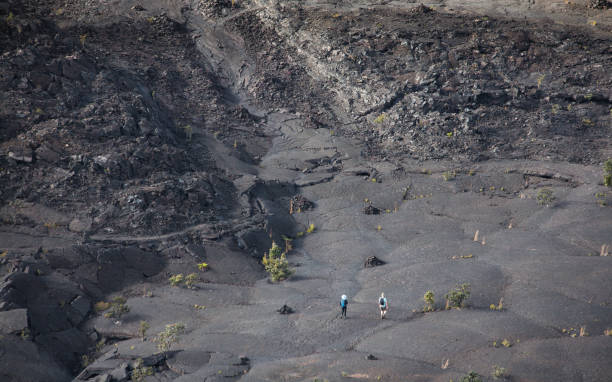 Hikers at Kilauea Iki Trail in Hawaii Volcanoes National Park stock photo