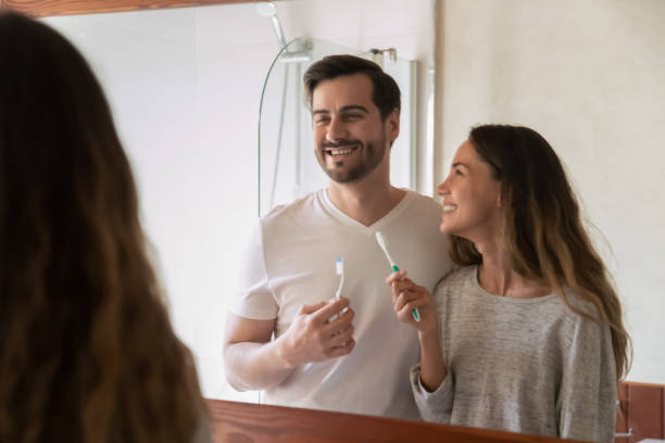 istock Happy young couple brush teeth in bathroom together 1207696881