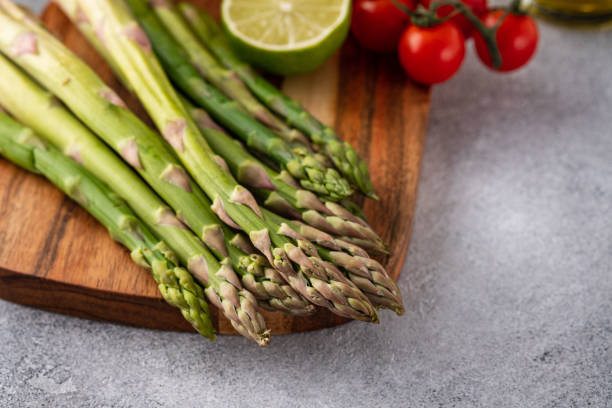 istock Tasty fresh vegetables for dinner or lunch ready to be cooked with ripe cherry tomatoes, lime, asparagus, eggs and olive oil. 1207698965