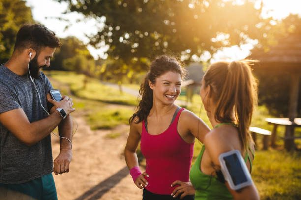istock Friends resting after a run in the forest and communicating 1207700834