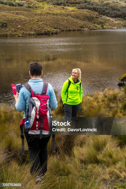 Two Beautiful Women Hiking And Enjoying The Beauty Of Nature At Lake In El Cajas National Park Ecuador Stock Photo - Download Image Now