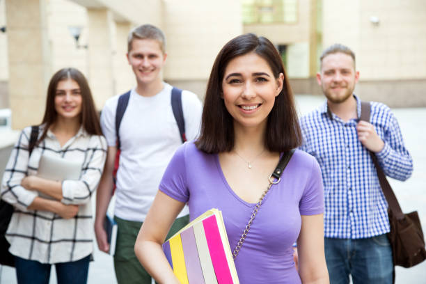 istock Female student outdoors with her friends 1207703742