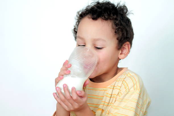 istock child drinking milk stock photo 1207703994