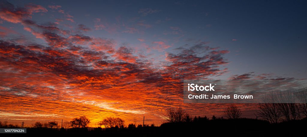 Beautiful sunrise in the countryside outside of Bushmills, Causeway coast, Northern Ireland Multicoloured sunrise on the Causeway Coast of Northern Ireland. Agricultural Field Stock Photo