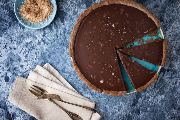 istock Chocolate tart with sea salt on blue table 1207706851