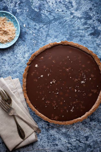 istock Chocolate tart with sea salt on blue table 1207706858