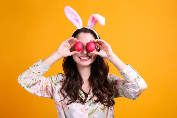 istock Joyful female posing for easter themed photoshoot with bunny ears. 1207707090