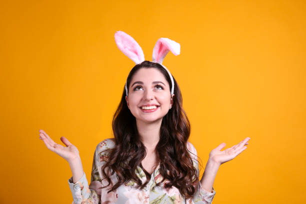 istock Joyful female posing for easter themed photoshoot with bunny ears. 1207707240