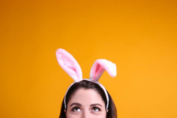 istock Joyful female posing for easter themed photoshoot with bunny ears. 1207707559