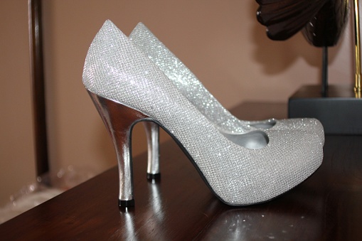 High-heeled silver shoes of the bride