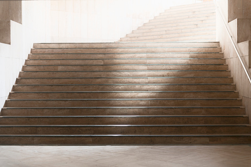 Beautiful marble staircase leading into bright light. Architectural detail from the mosque Hassan II in Casablanca, Morocco. Soft focus, glow effect.