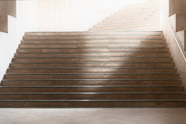 Beautiful marble staircase leading into bright light. stock photo