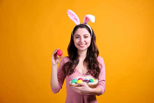 istock Joyful female posing for easter themed photoshoot with bunny ears. 1207707630