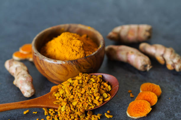 istock Turmeric powder and turmeric roots 1207707678