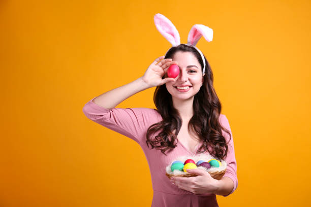 istock Joyful female posing for easter themed photoshoot with bunny ears. 1207708297